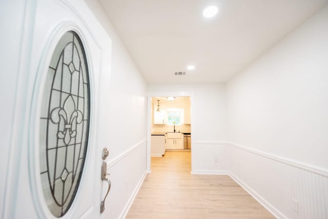 1025 Hathaway Ln, Marque, TX 77568 - entryway featuring light wood-type flooring, recessed lighting, and wainscoting