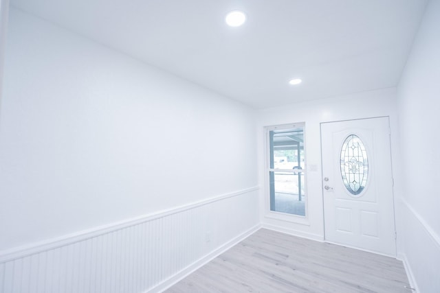 1025 Hathaway Ln, Marque, TX 77568 - entryway with light wood-style flooring, wainscoting, and recessed lighting