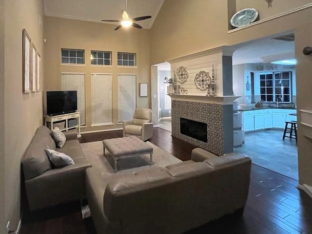 7922 Scenic Canyon Ln W, Houston, TX 77095 - living room with dark wood-style floors, ceiling fan, a tiled fireplace, and high vaulted ceiling