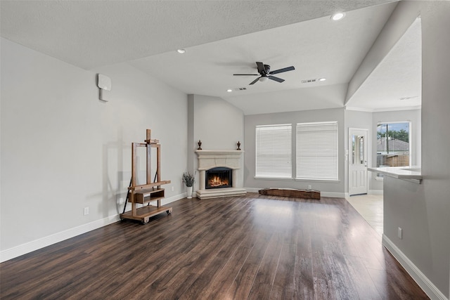 23826 Spring Dane Dr, Spring, TX 77373 - unfurnished living room featuring a lit fireplace, ceiling fan, wood finished floors, recessed lighting, and a textured ceiling