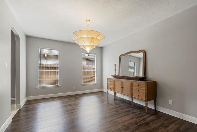 23826 Spring Dane Dr, Spring, TX 77373 - unfurnished room with arched walkways, dark wood-type flooring, and a textured ceiling
