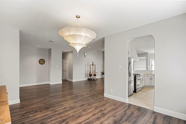 23826 Spring Dane Dr, Spring, TX 77373 - empty room with light wood-style flooring, arched walkways, and recessed lighting