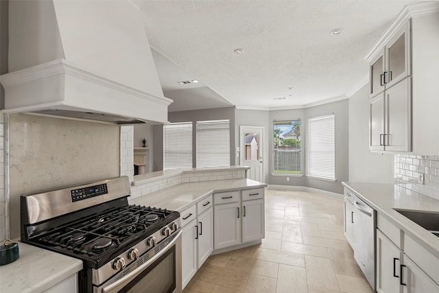 23826 Spring Dane Dr, Spring, TX 77373 - kitchen featuring appliances with stainless steel finishes, custom exhaust hood, tasteful backsplash, recessed lighting, and ornamental molding