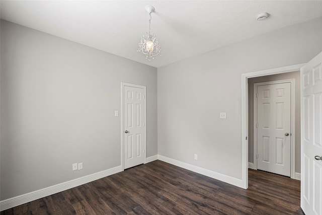 23826 Spring Dane Dr, Spring, TX 77373 - spare room featuring dark wood finished floors and a chandelier