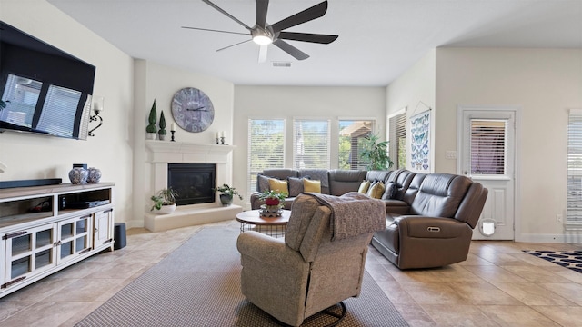 15314 Icet Creek Ave, Mont Belvieu, TX 77523 - living area with ceiling fan, a glass covered fireplace, and light tile patterned floors