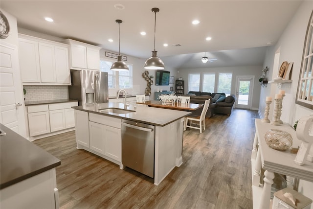 20503 Montecrest Cir, Spring, TX 77379 - kitchen with stainless steel appliances, healthy amount of natural light, tasteful backsplash, wood finished floors, and recessed lighting