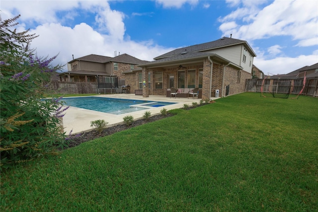 20503 Montecrest Cir, Spring, TX 77379 - back of property featuring brick siding, a fenced backyard, a patio, ceiling fan, and a pool with connected hot tub