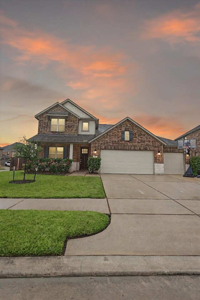20503 Montecrest Cir, Spring, TX 77379 - view of front of home with an attached garage, concrete driveway, a yard, and brick siding