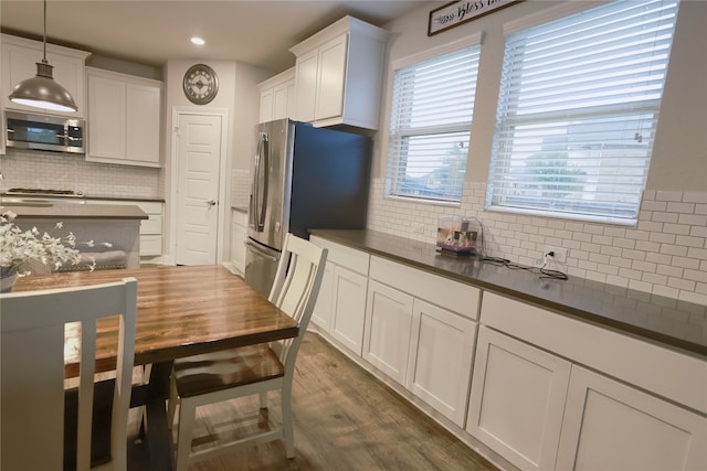 20503 Montecrest Cir, Spring, TX 77379 - kitchen featuring stainless steel appliances, dark countertops, backsplash, white cabinets, and dark wood-style flooring