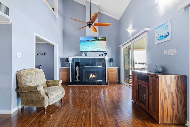325 Carolcrest Ln Unit 2, Livingston, TX 77351 - living room with crown molding, high vaulted ceiling, ceiling fan, a tiled fireplace, and dark wood-style floors