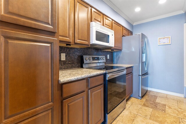 325 Carolcrest Ln Unit 2, Livingston, TX 77351 - kitchen with appliances with stainless steel finishes, ornamental molding, tasteful backsplash, stone tile flooring, and recessed lighting