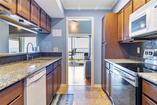 325 Carolcrest Ln Unit 2, Livingston, TX 77351 - kitchen with white appliances, healthy amount of natural light, tasteful backsplash, and crown molding