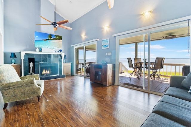 325 Carolcrest Ln Unit 2, Livingston, TX 77351 - living room with high vaulted ceiling, crown molding, a ceiling fan, wood finished floors, and a tile fireplace