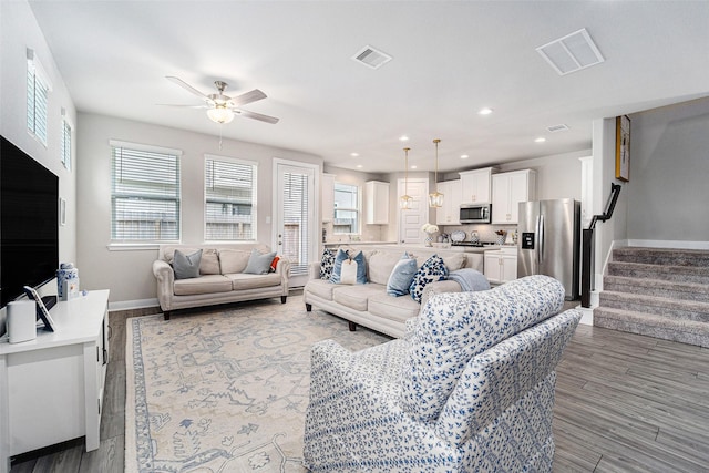 4101 Split Ivy Dr, Houston, TX 77080 - living area with a ceiling fan, wood finished floors, stairway, and recessed lighting