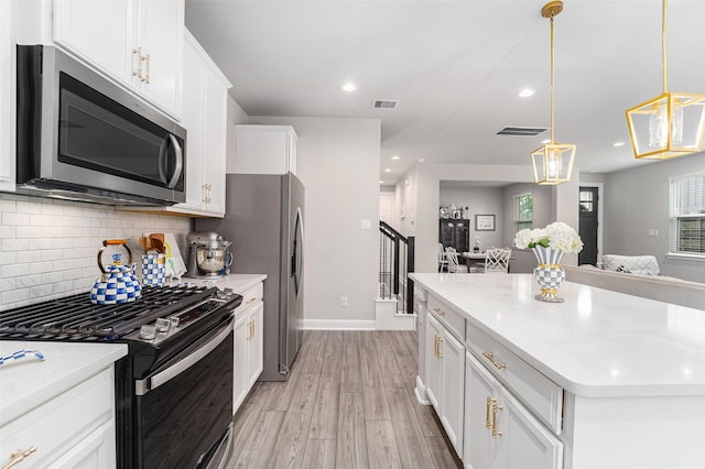4101 Split Ivy Dr, Houston, TX 77080 - kitchen featuring appliances with stainless steel finishes, backsplash, white cabinets, light wood-style floors, and light countertops