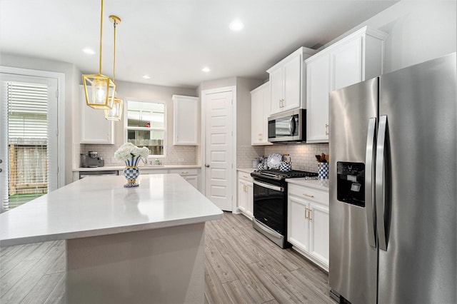 4101 Split Ivy Dr, Houston, TX 77080 - kitchen with appliances with stainless steel finishes, light wood-style floors, white cabinets, light countertops, and recessed lighting