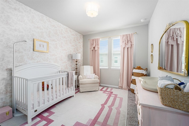 4101 Split Ivy Dr, Houston, TX 77080 - bedroom featuring wallpapered walls, a crib, and light colored carpet
