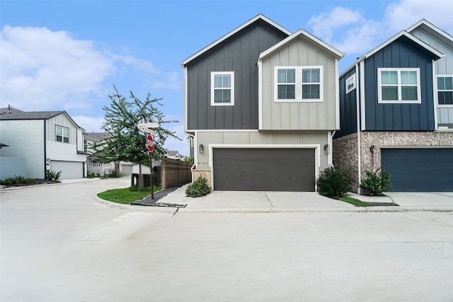 4101 Split Ivy Dr, Houston, TX 77080 - view of front of property with board and batten siding, concrete driveway, and a garage