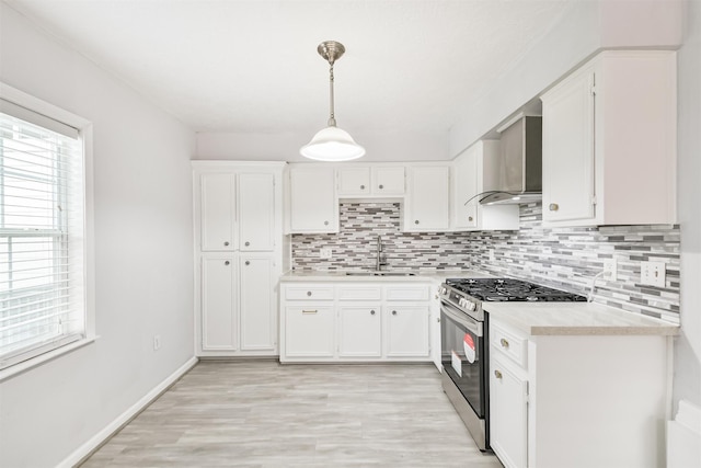 10329 Fairfax St, Houston, TX 77029 - kitchen featuring stainless steel gas range oven, wall chimney exhaust hood, light countertops, and decorative backsplash