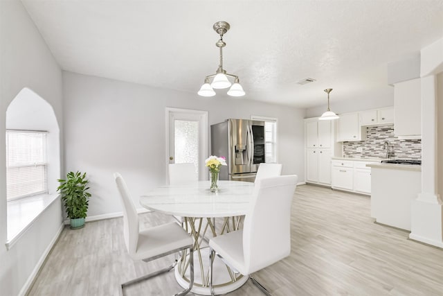 10329 Fairfax St, Houston, TX 77029 - dining room featuring light wood finished floors and plenty of natural light