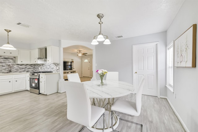 10329 Fairfax St, Houston, TX 77029 - dining room featuring light wood-style flooring and ceiling fan