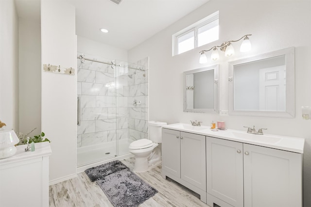 10329 Fairfax St, Houston, TX 77029 - bathroom featuring double vanity, a stall shower, and wood finished floors