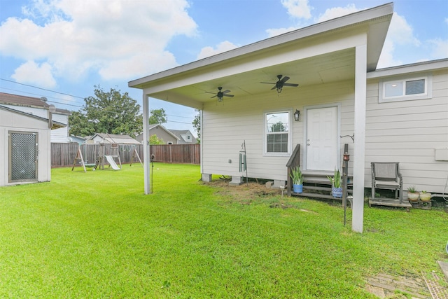 10329 Fairfax St, Houston, TX 77029 - rear view of property featuring a fenced backyard, a ceiling fan, a playground, and entry steps