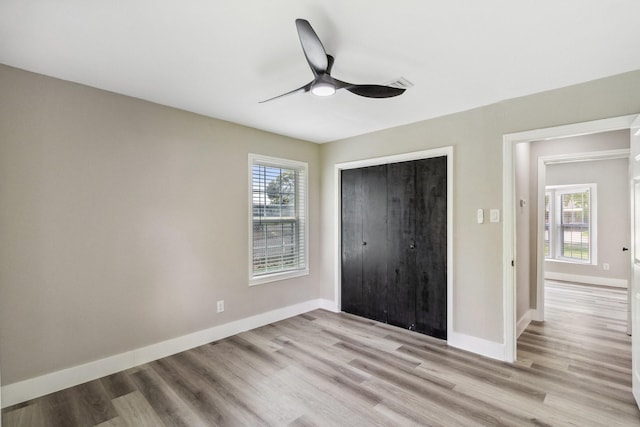 1000 W Thomas Ave, Pasadena, TX 77506 - unfurnished bedroom with multiple windows, a closet, light wood-style flooring, and ceiling fan