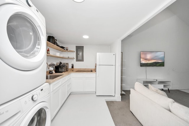 10747 Dulcimer St, Houston, TX 77051 - laundry area featuring estacked washer and dryer, electric panel, and recessed lighting