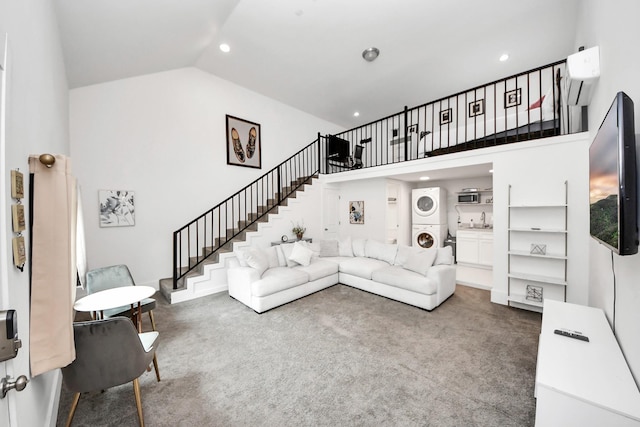 10747 Dulcimer St, Houston, TX 77051 - living room featuring stacked washing machine and dryer, stairway, carpet floors, a wall mounted air conditioner, and high vaulted ceiling