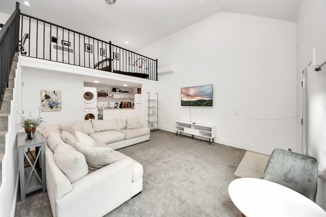 10747 Dulcimer St, Houston, TX 77051 - living area with stacked washing machine and dryer, high vaulted ceiling, stairway, carpet flooring, and a wall mounted air conditioner