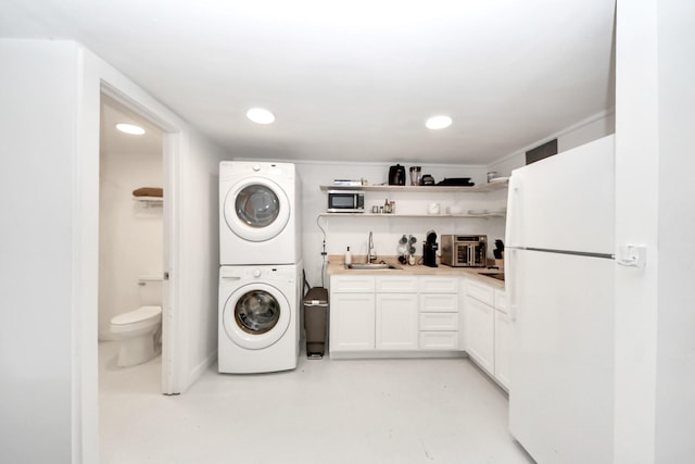 10747 Dulcimer St, Houston, TX 77051 - washroom with estacked washer and dryer, recessed lighting, and wet bar