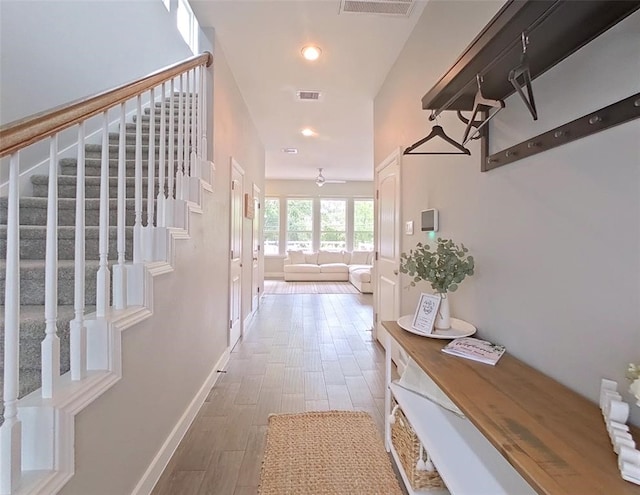 10747 Dulcimer St, Houston, TX 77051 - hallway with stairway, wood finished floors, and recessed lighting
