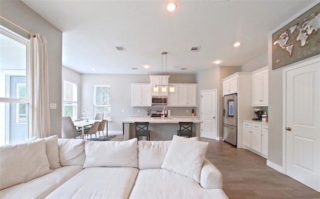 10747 Dulcimer St, Houston, TX 77051 - living area featuring wood finished floors and recessed lighting
