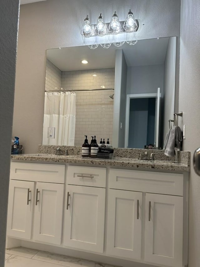 10747 Dulcimer St, Houston, TX 77051 - full bath with double vanity, tiled shower, and marble finish floors