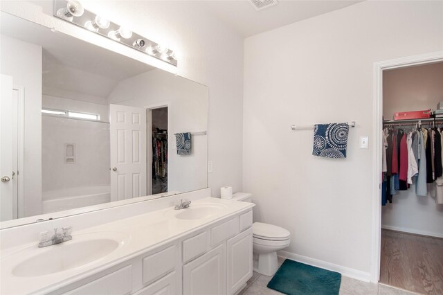 21515 Oak Park Trails Dr, Katy, TX 77450 - bathroom featuring double vanity, a spacious closet, and  shower combination