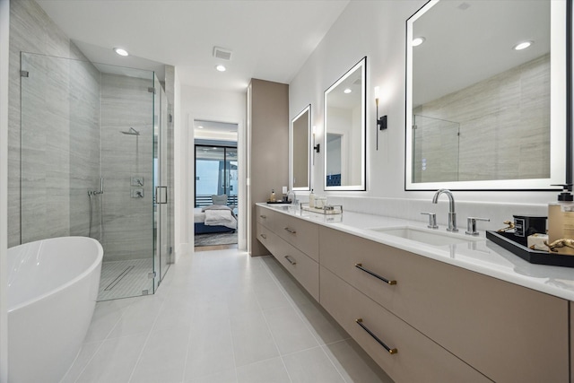 507 W Bell, Houston, TX 77019 - ensuite bathroom with a soaking tub, double vanity, a shower stall, tile patterned flooring, and recessed lighting