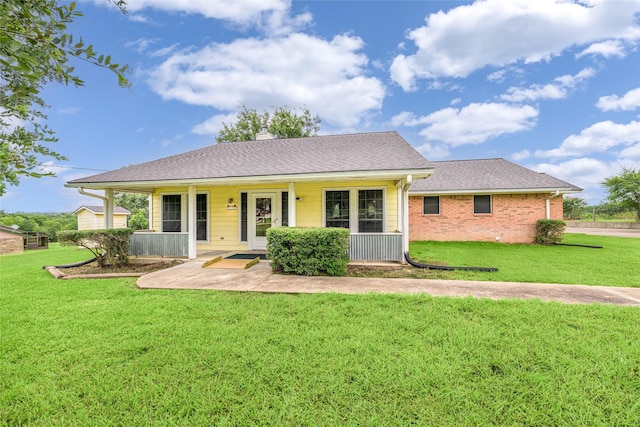 7027 Kurt Dr, Brenham, TX 77833 - view of front of home with a front lawn, covered porch, a chimney, and a shingled roof