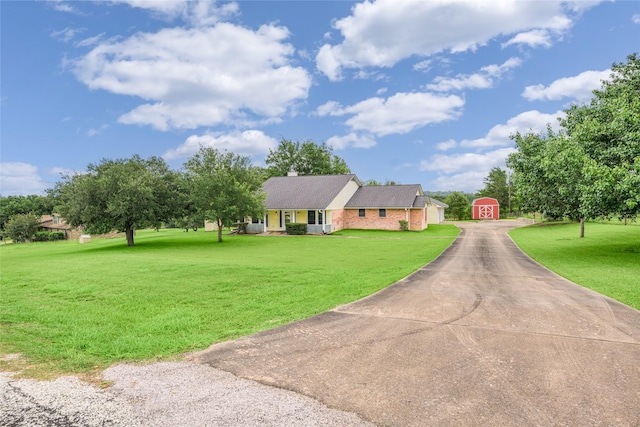 7027 Kurt Dr, Brenham, TX 77833 - single story home with a shed, driveway, and a front yard