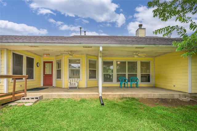 7027 Kurt Dr, Brenham, TX 77833 - rear view of property with a ceiling fan, a yard, a chimney, a patio area, and a shingled roof