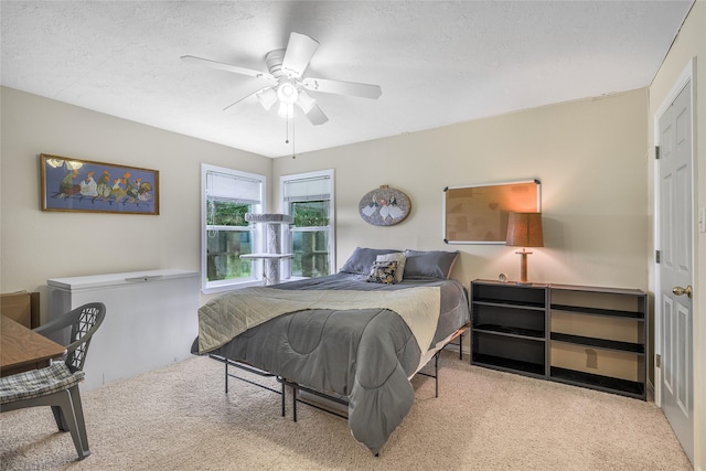 7027 Kurt Dr, Brenham, TX 77833 - carpeted bedroom featuring ceiling fan and a textured ceiling