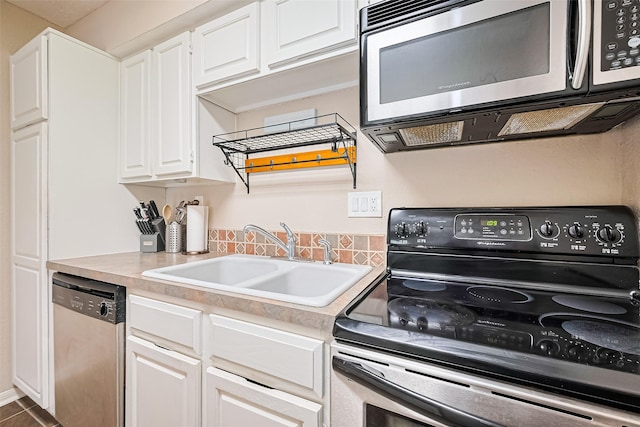 1860 White Oak Dr Unit 334, Houston, TX 77009 - kitchen with appliances with stainless steel finishes, light countertops, white cabinets, and tile patterned floors