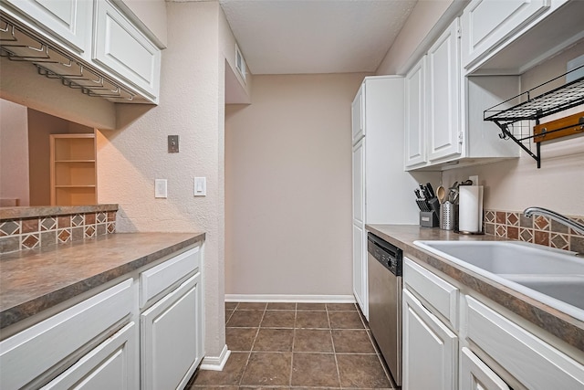 1860 White Oak Dr Unit 334, Houston, TX 77009 - kitchen with stainless steel dishwasher, white cabinets, and dark tile patterned flooring