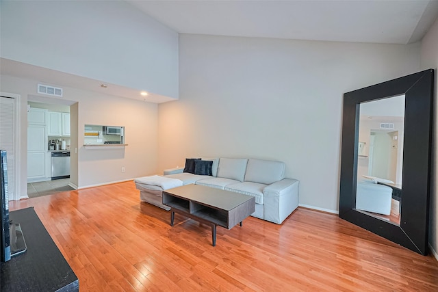 1860 White Oak Dr Unit 334, Houston, TX 77009 - living room featuring light wood finished floors and high vaulted ceiling