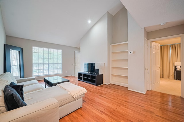 1860 White Oak Dr Unit 334, Houston, TX 77009 - living area featuring built in shelves, light wood-style floors, high vaulted ceiling, and recessed lighting