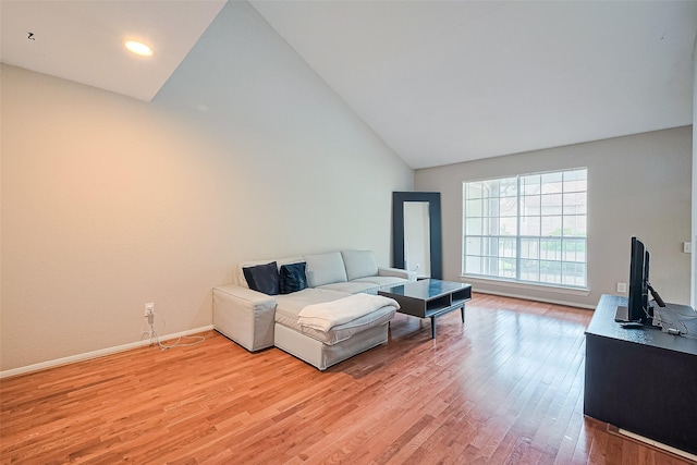 1860 White Oak Dr Unit 334, Houston, TX 77009 - living room with vaulted ceiling and light wood-style flooring