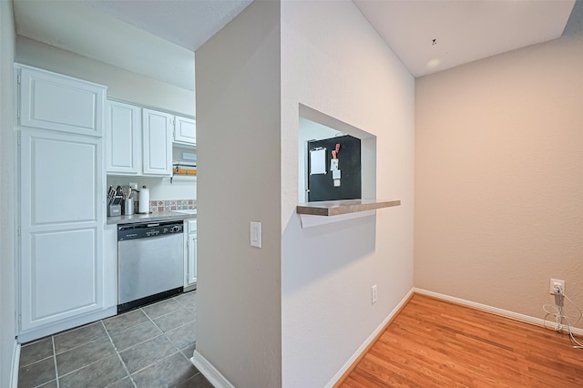 1860 White Oak Dr Unit 334, Houston, TX 77009 - kitchen with dishwasher, white cabinets, light wood-style floors, and light countertops