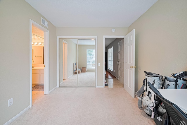 1860 White Oak Dr Unit 334, Houston, TX 77009 - bedroom with light carpet, a closet, and ensuite bathroom