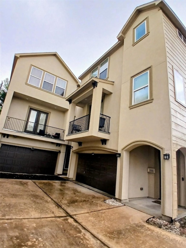 3333 Kilgore St, Houston, TX 77021 - view of front of property with an attached garage, a balcony, stucco siding, and driveway