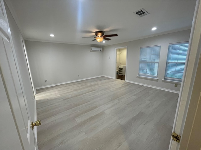12834 Tosca Ln, Houston, TX 77024 - unfurnished room featuring a ceiling fan, a wall mounted AC, light wood finished floors, recessed lighting, and crown molding
